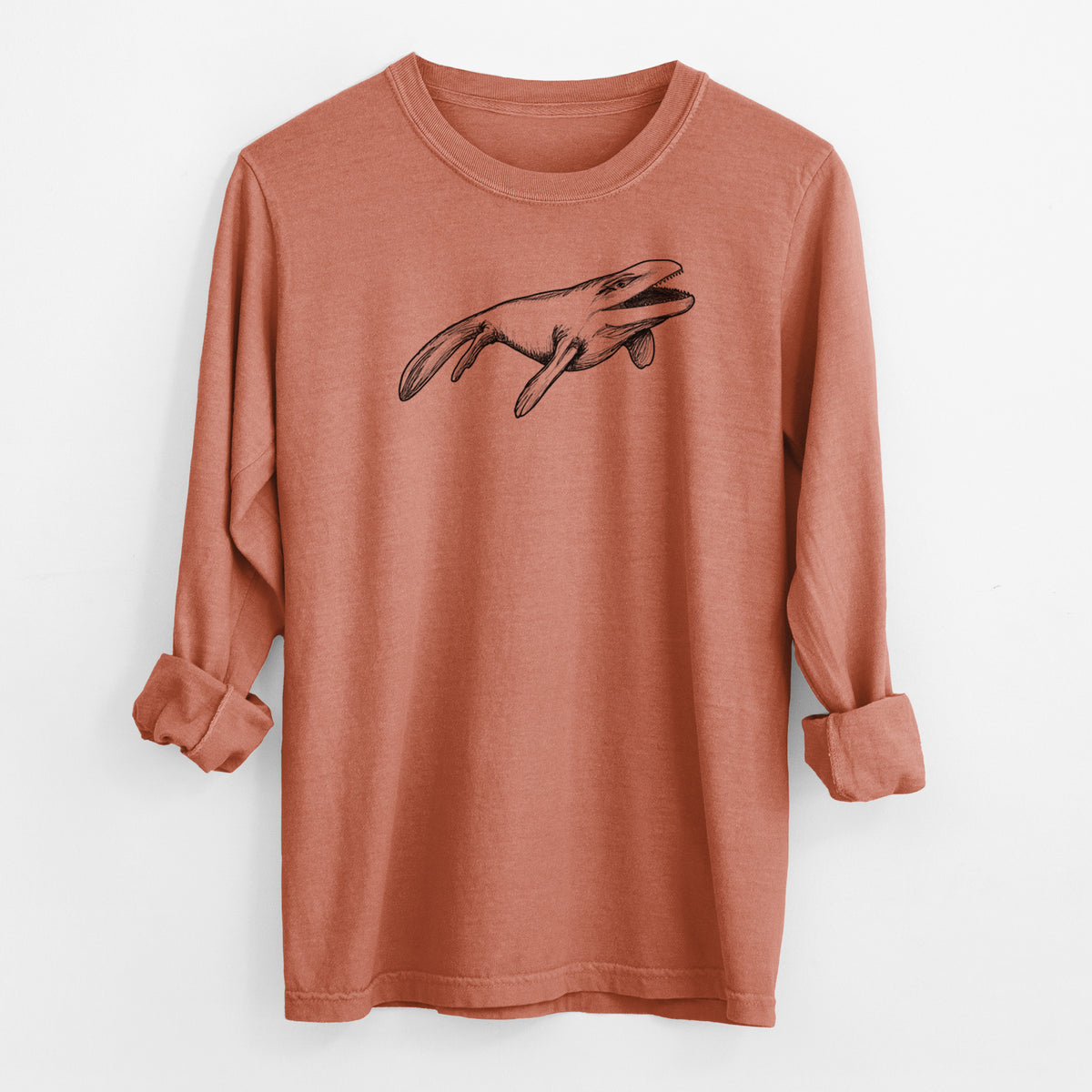 Yam burnt orange Comfort Colors long sleeve shirt laid flat with the cuffs rolled, printed with a black ink illustration of a Mosasaur swimming.