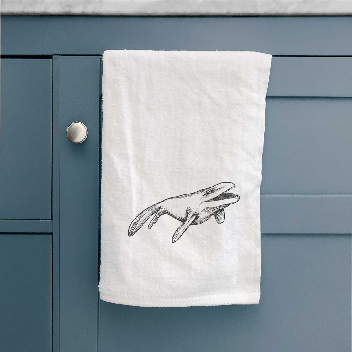White hand towel printed with a black ink illustration of a Mosasaur swimming.