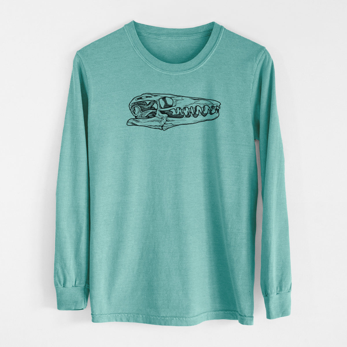 Reef green Comfort Colors long sleeve shirt laid flat, printed with a detailed black ink illustration of a Mosasaur skull.