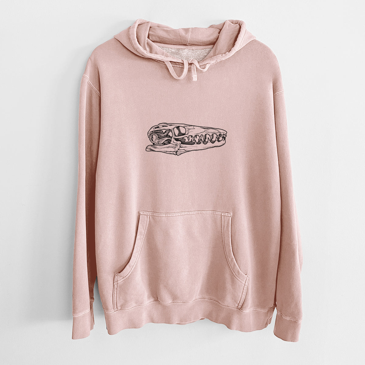 Dusty pink pigment dyed hoodie laid flat, printed with a detailed black ink illustration of a Mosasaur skull.