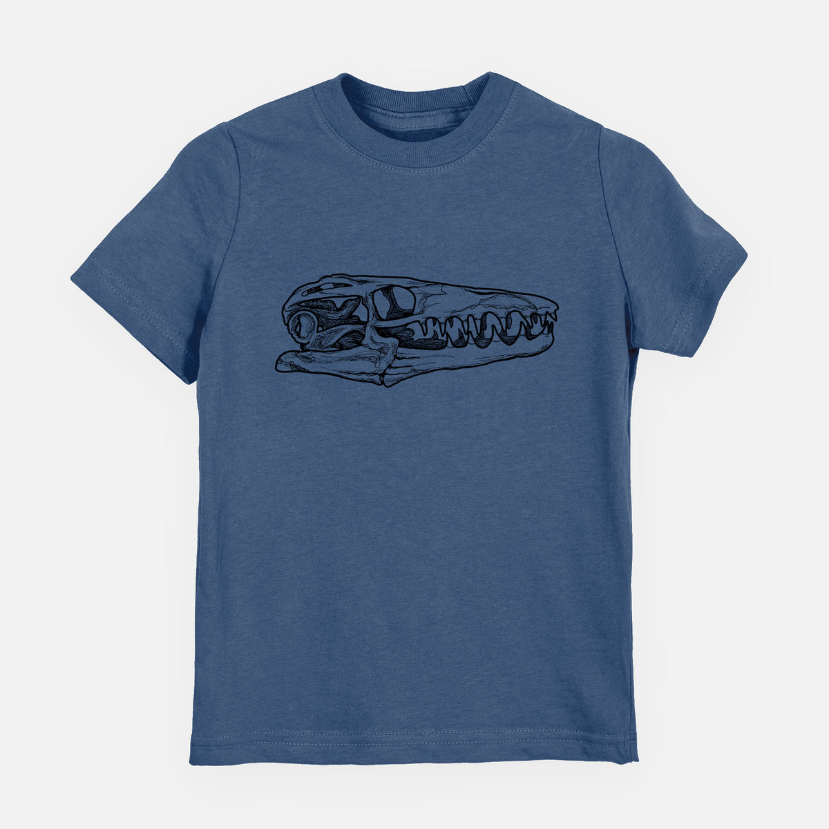 Indigo blue youth t-shirt laid flat, printed with a detailed black ink illustration of a Mosasaur skull.