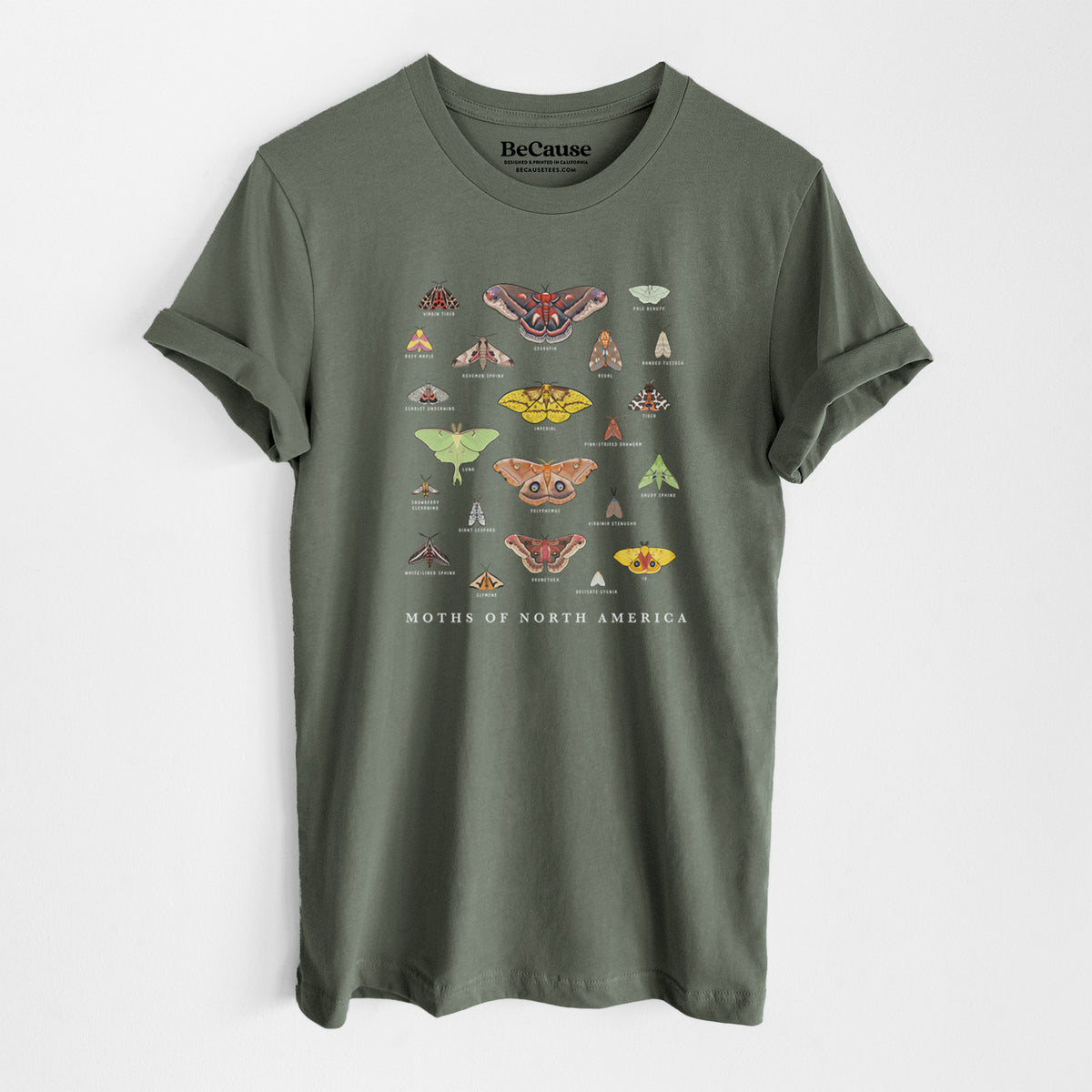 Military green lightweight cotton t-shirt laid flat, printed with a full-color chart of North American moths, each labeled with its species.