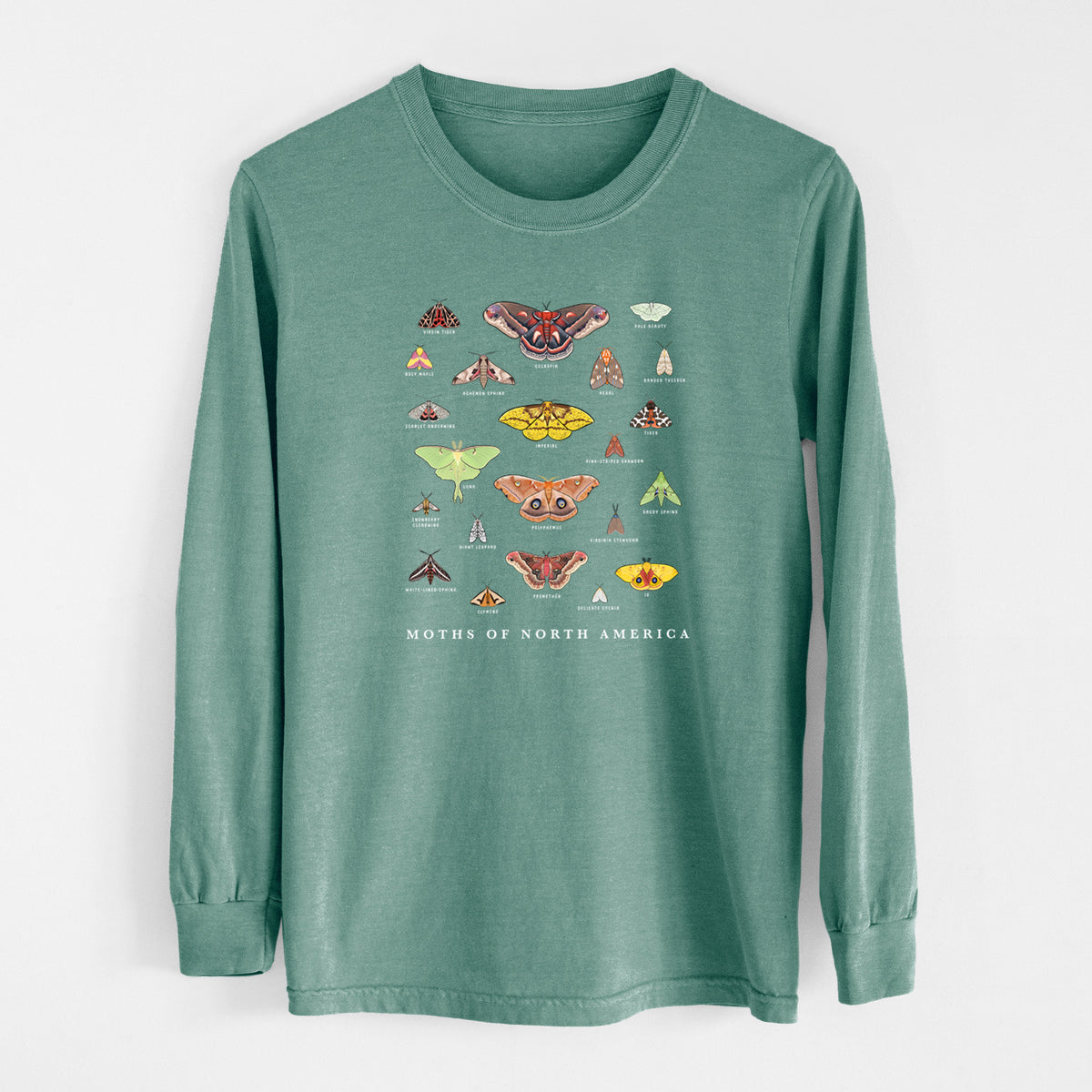 Pine green Comfort Colors long sleeve shirt laid flat, printed with a full-color chart of North American moths, each labeled with its species.
