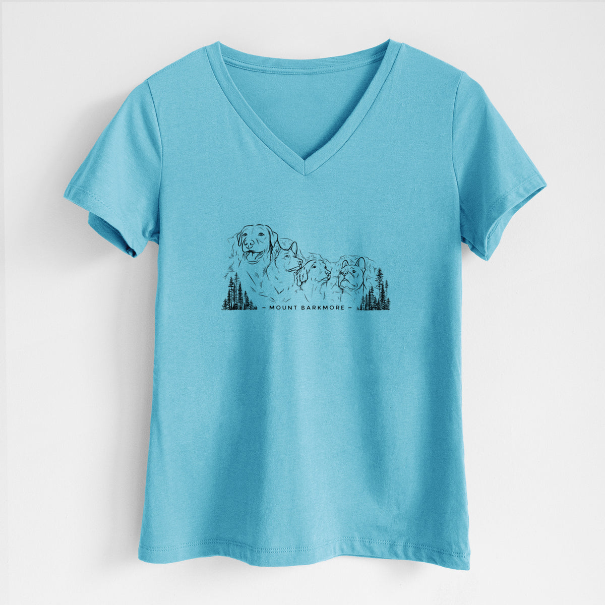 Turquoise women's relaxed fit cotton V-neck t-shirt laid flat, printed with a black ink illustration of four dog faces carved into a mountain, with the words Mount Barkmore.