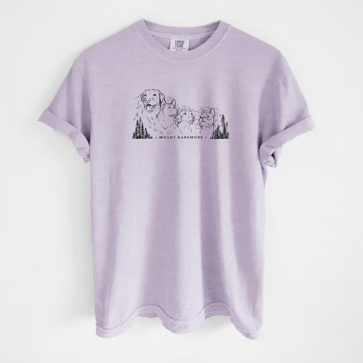 Orchid purple Comfort Colors t-shirt laid flat, printed with a black ink illustration of four dog faces carved into a mountain, with the words Mount Barkmore.