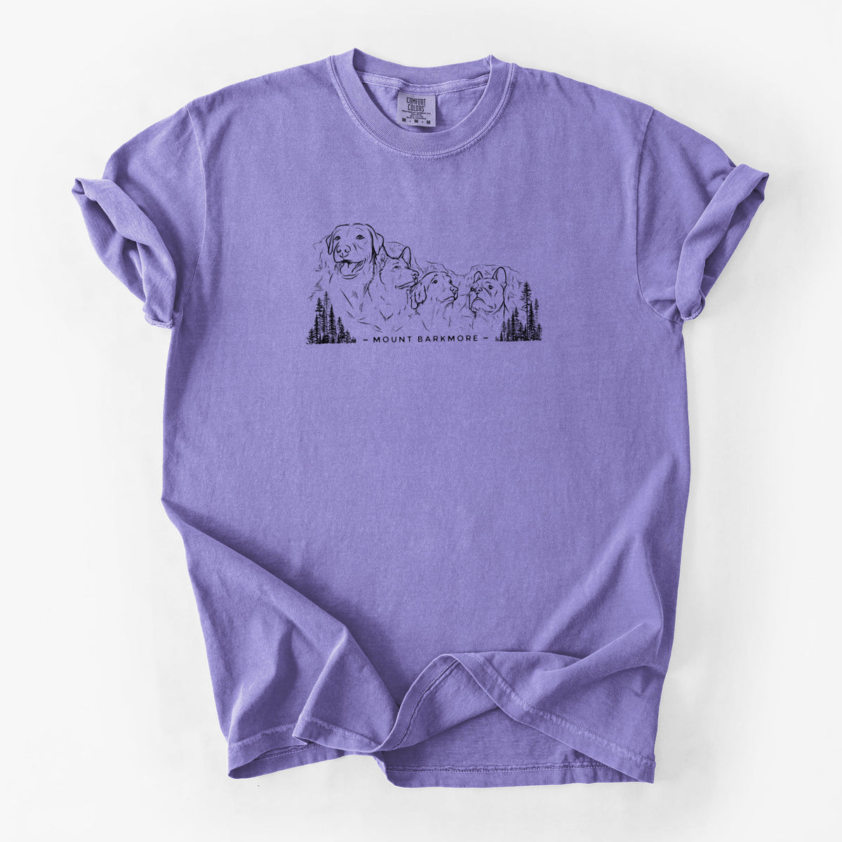 Violet purple Comfort Colors t-shirt laid flat, printed with a black ink illustration of four dog faces carved into a mountain, with the words Mount Barkmore.