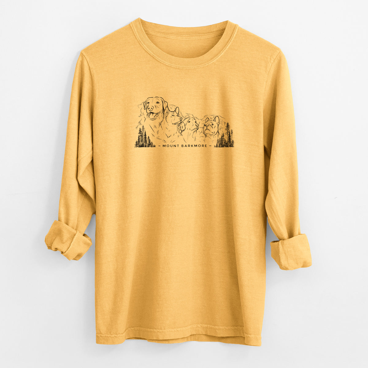 Golden wheat yellow Comfort Colors long sleeve shirt laid flat with the cuffs rolled, printed with a black ink illustration of four dog faces carved into a mountain, with the words Mount Barkmore.