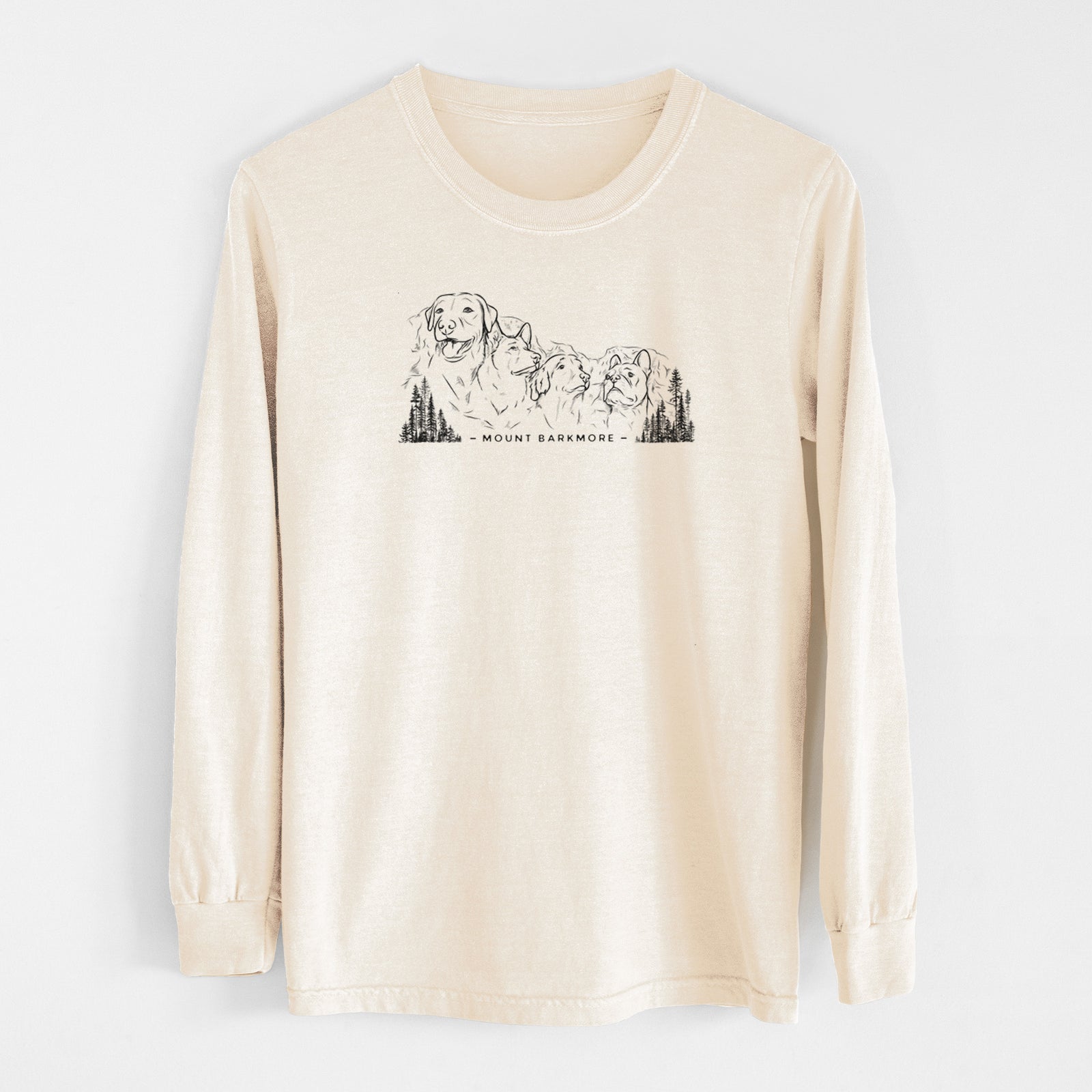 Ivory Comfort Colors long sleeve shirt laid flat, printed with a black ink illustration of four dog faces carved into a mountain, with the words Mount Barkmore.