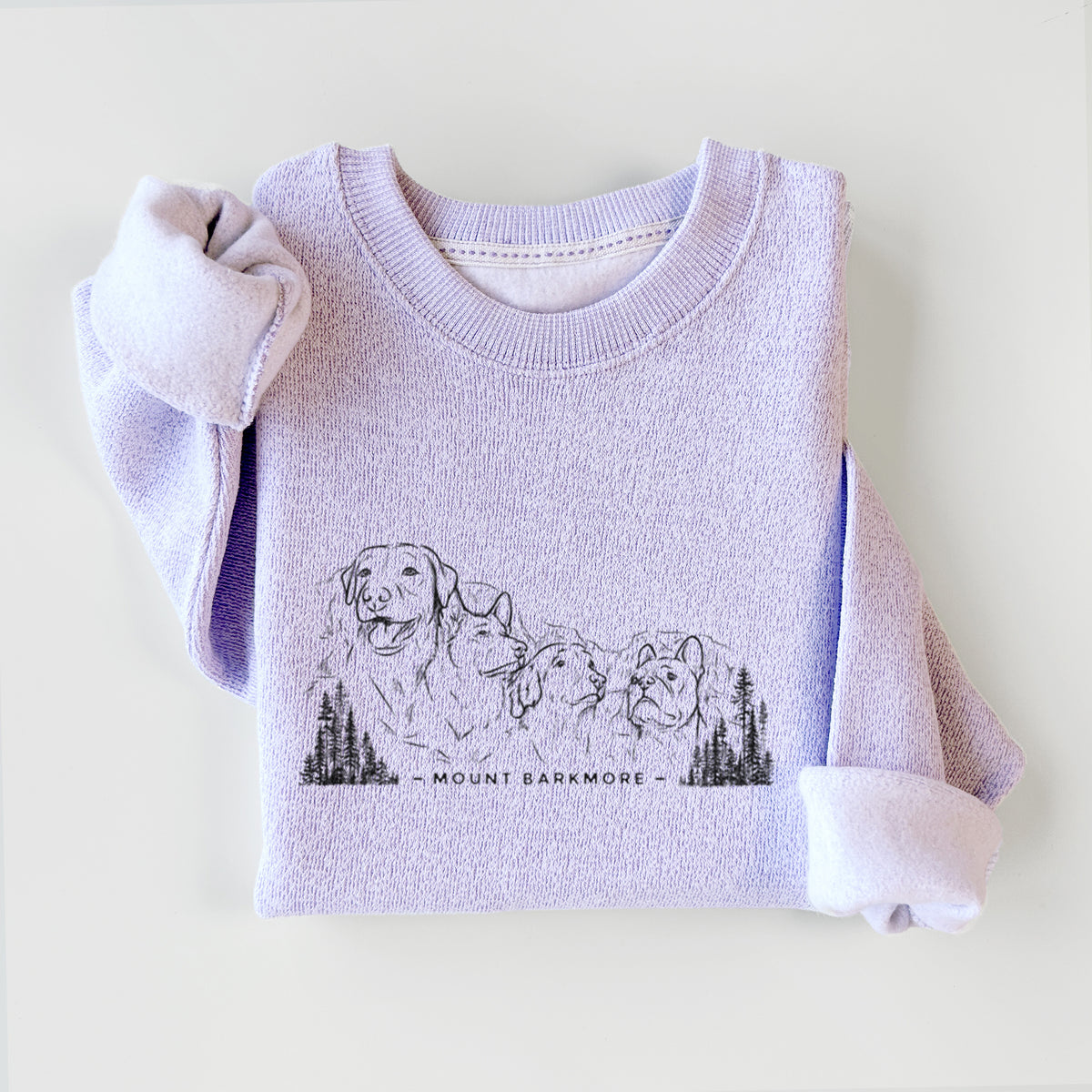 Ice purple knit sweatshirt printed with a black ink illustration of four dog faces carved into a mountain, with the words Mount Barkmore, styled flat.