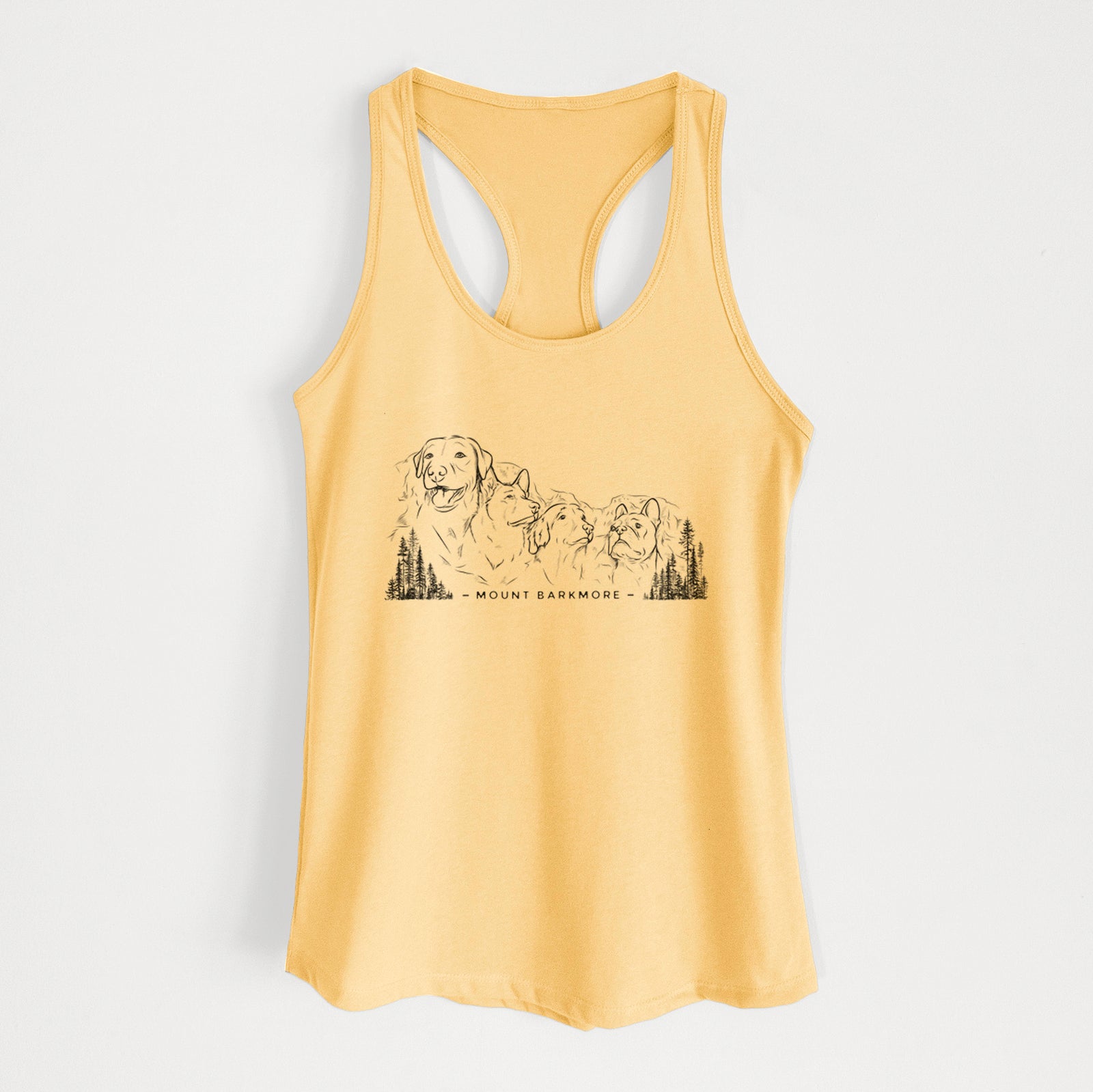 Banana cream women's racerback tank top laid flat, printed with a black ink illustration of four dog faces carved into a mountain, with the words Mount Barkmore.