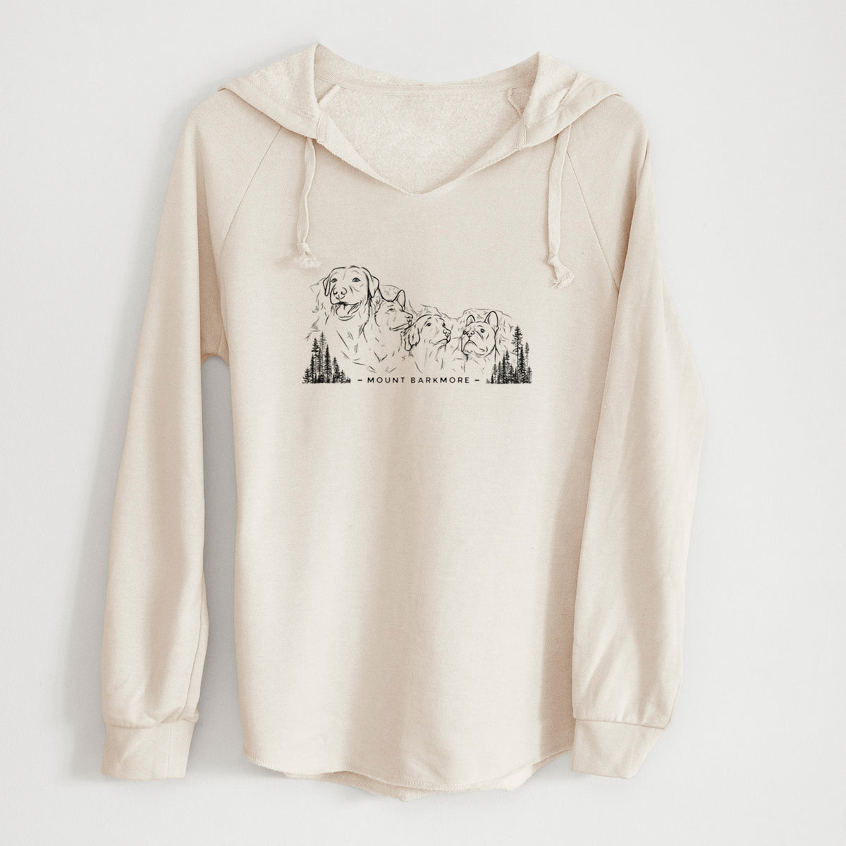 Bone cream women's Cali Wave hooded sweatshirt laid flat, printed with a black ink illustration of four dog faces carved into a mountain, with the words Mount Barkmore.