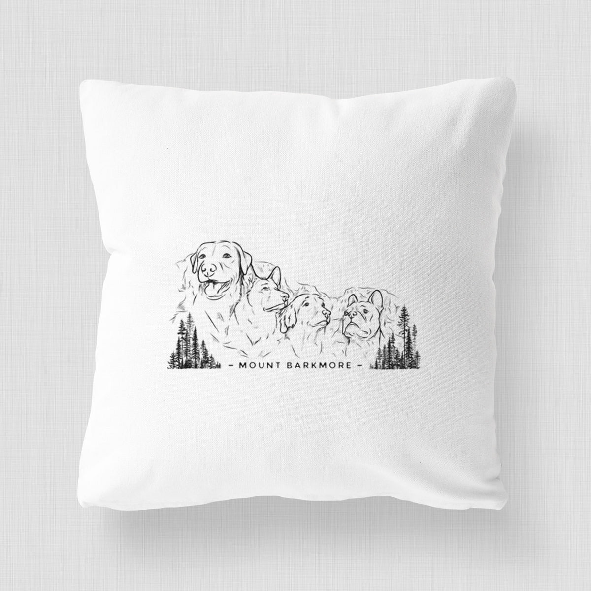 White pillow cover printed with a black ink illustration of four dog faces carved into a mountain, with the words Mount Barkmore.