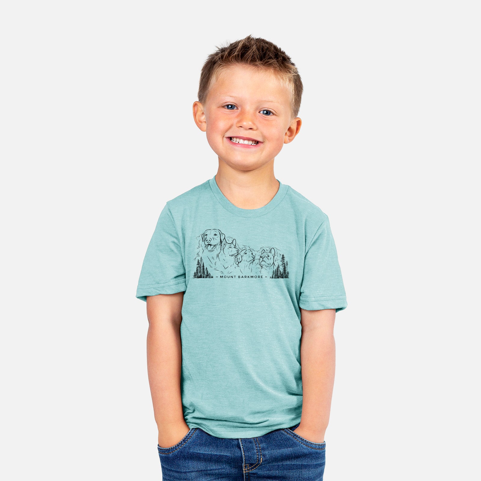 Two youth t-shirts in different colors on hangers, printed with a black ink illustration of four dog faces carved into a mountain, with the words Mount Barkmore.