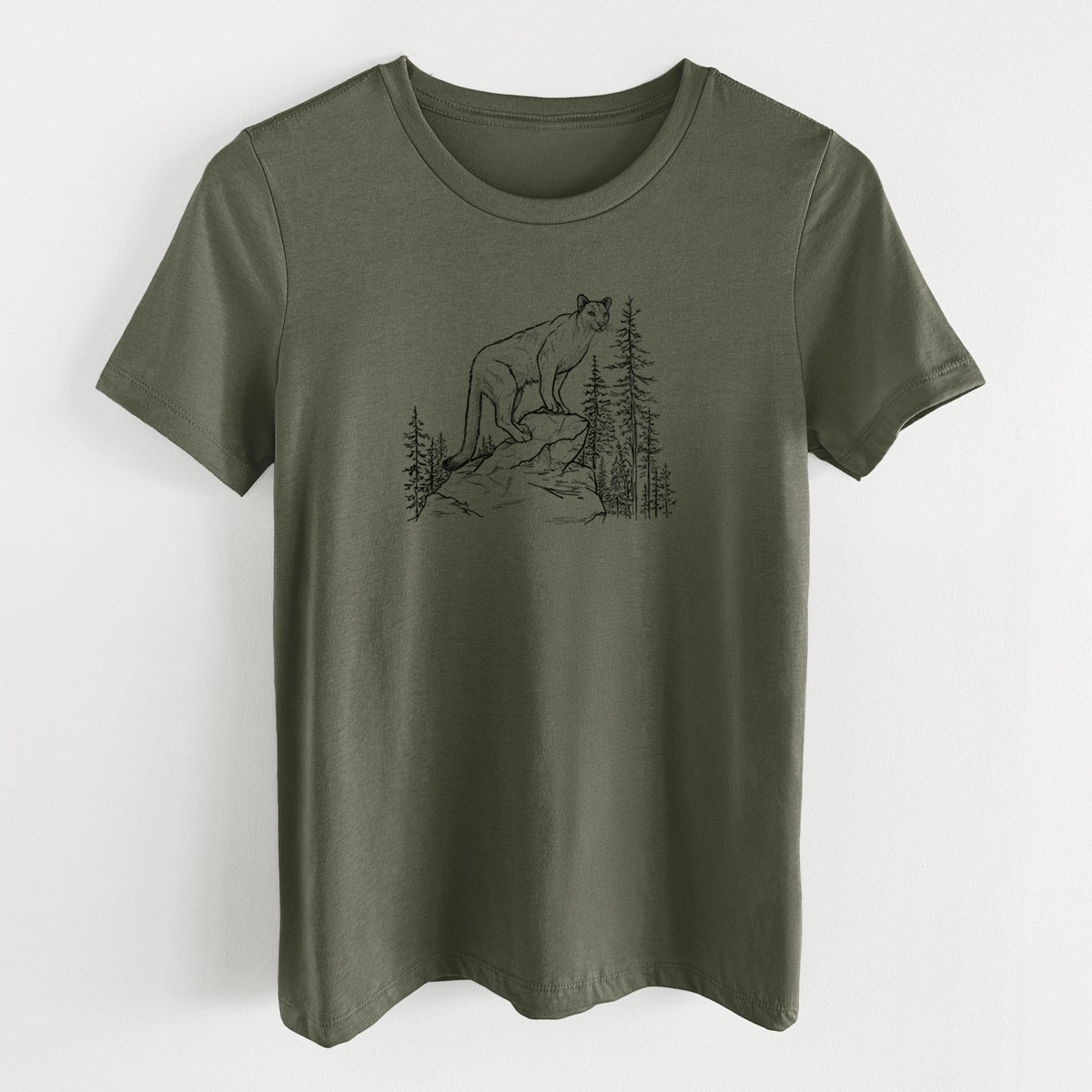 Military green women's relaxed fit cotton t-shirt laid flat, printed with a black ink illustration of a mountain lion standing on a rocky ledge among pine trees.
