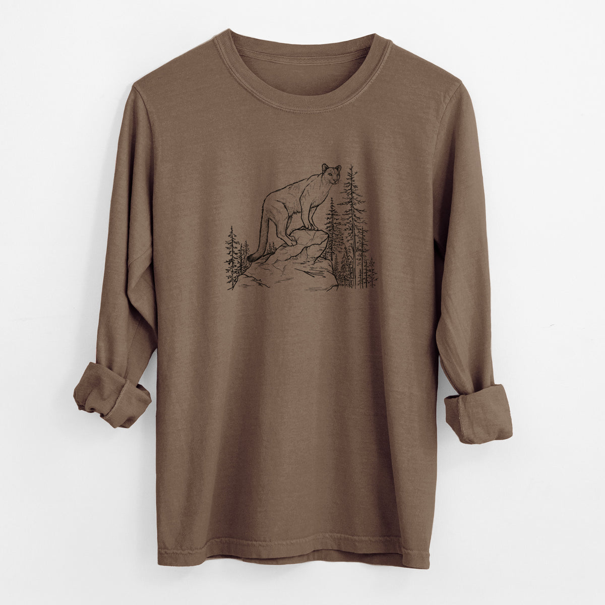 Espresso brown Comfort Colors long sleeve shirt laid flat with the cuffs rolled, printed with a black ink illustration of a mountain lion standing on a rocky ledge among pine trees.