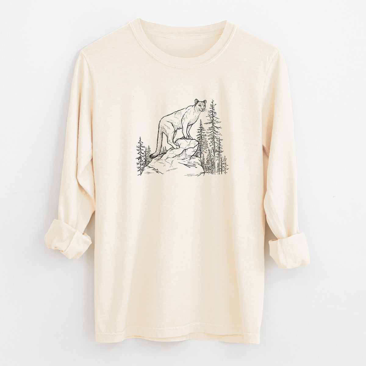 Ivory Comfort Colors long sleeve shirt laid flat with the cuffs rolled, printed with a black ink illustration of a mountain lion standing on a rocky ledge among pine trees.