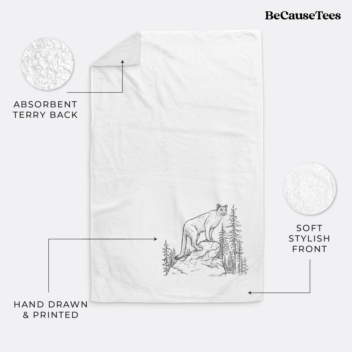 White hand towel printed with a black ink illustration of a mountain lion standing on a rocky ledge among pine trees.