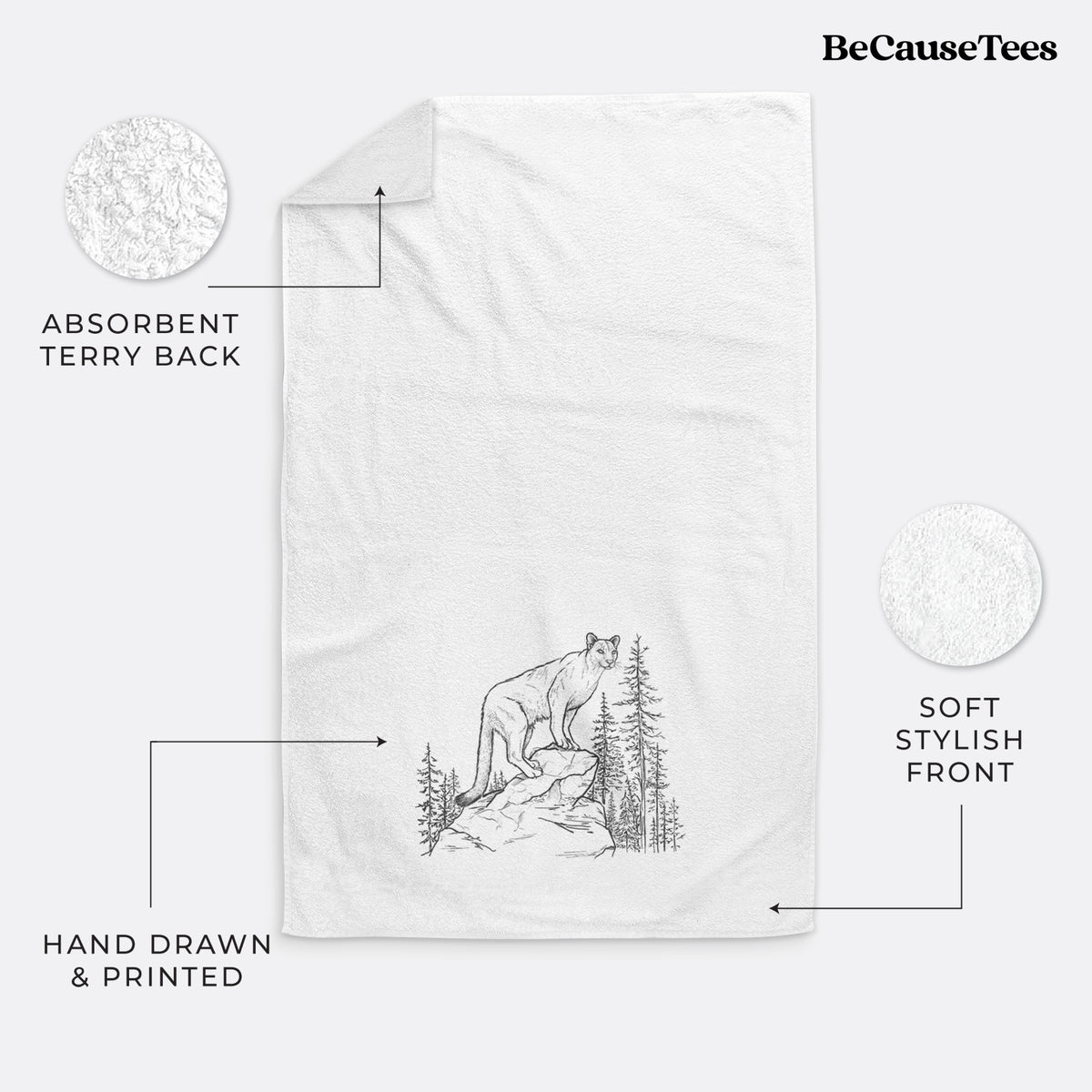 White hand towel printed with a black ink illustration of a mountain lion standing on a rocky ledge among pine trees.