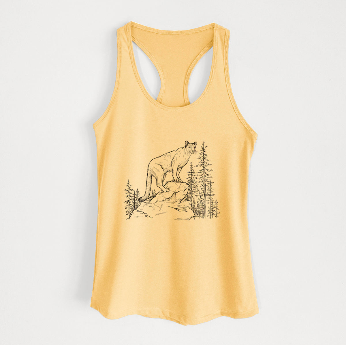 Banana cream women's racerback tank top laid flat, printed with a black ink illustration of a mountain lion standing on a rocky ledge among pine trees.