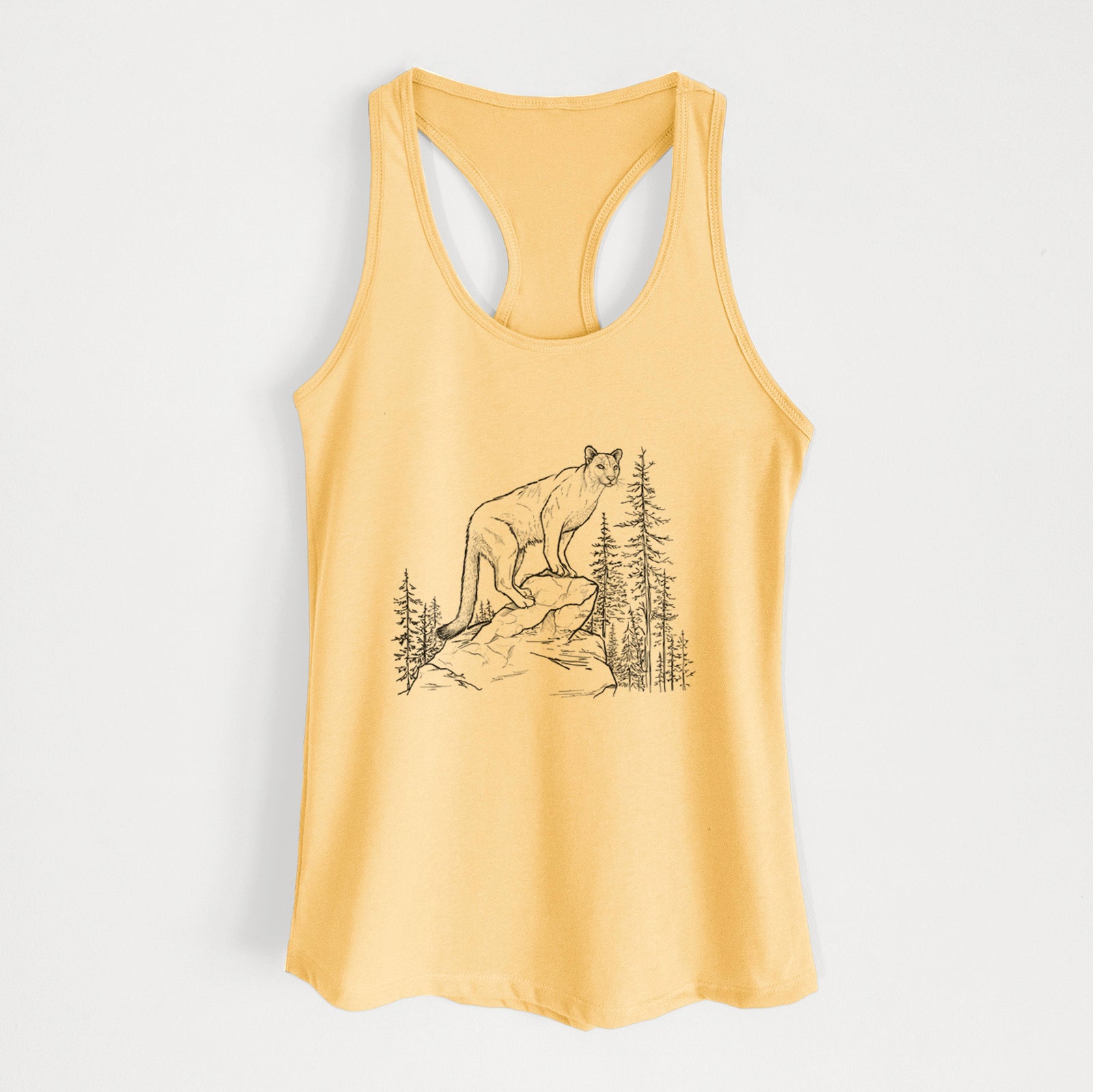 Banana cream women's racerback tank top laid flat, printed with a black ink illustration of a mountain lion standing on a rocky ledge among pine trees.