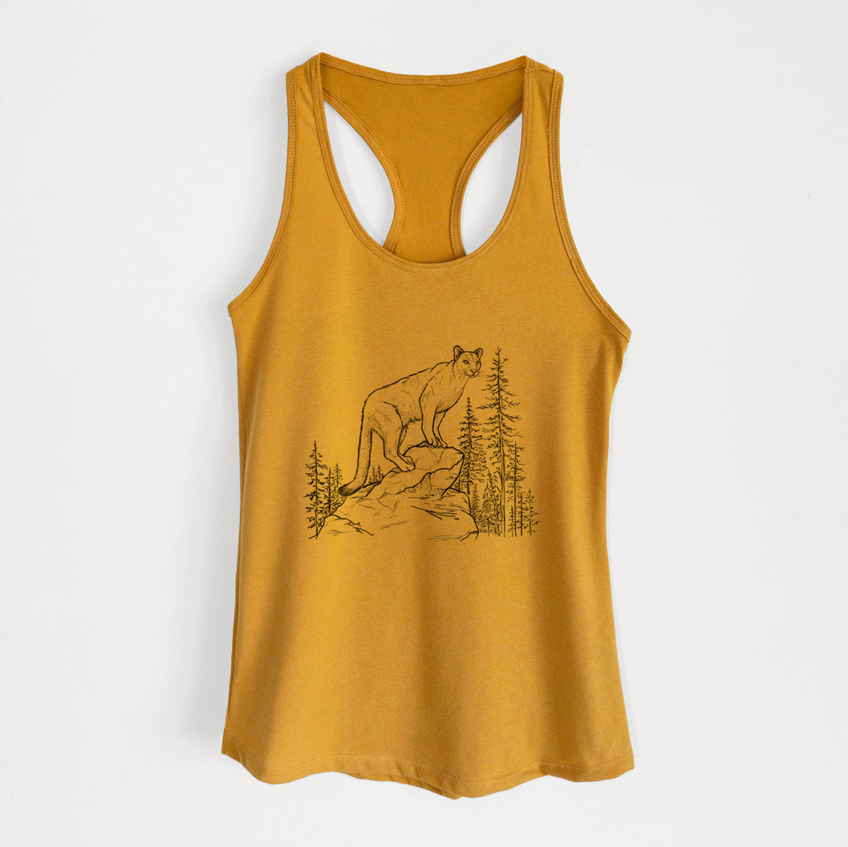 Gold women's racerback tank top laid flat, printed with a black ink illustration of a mountain lion standing on a rocky ledge among pine trees.