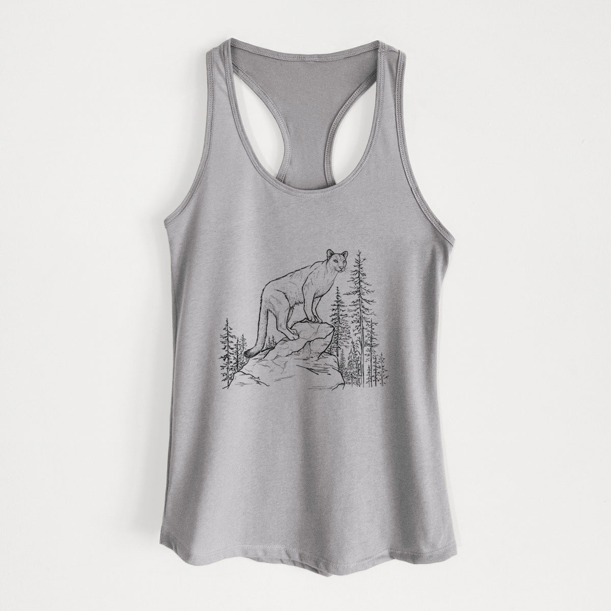Heather grey women's racerback tank top laid flat, printed with a black ink illustration of a mountain lion standing on a rocky ledge among pine trees.