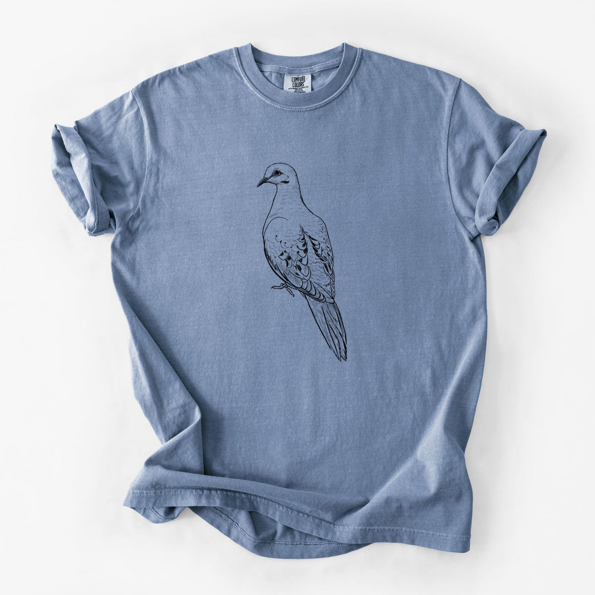 Blue jean Comfort Colors t-shirt laid flat, printed with a detailed black ink sketch of a mourning dove perched.