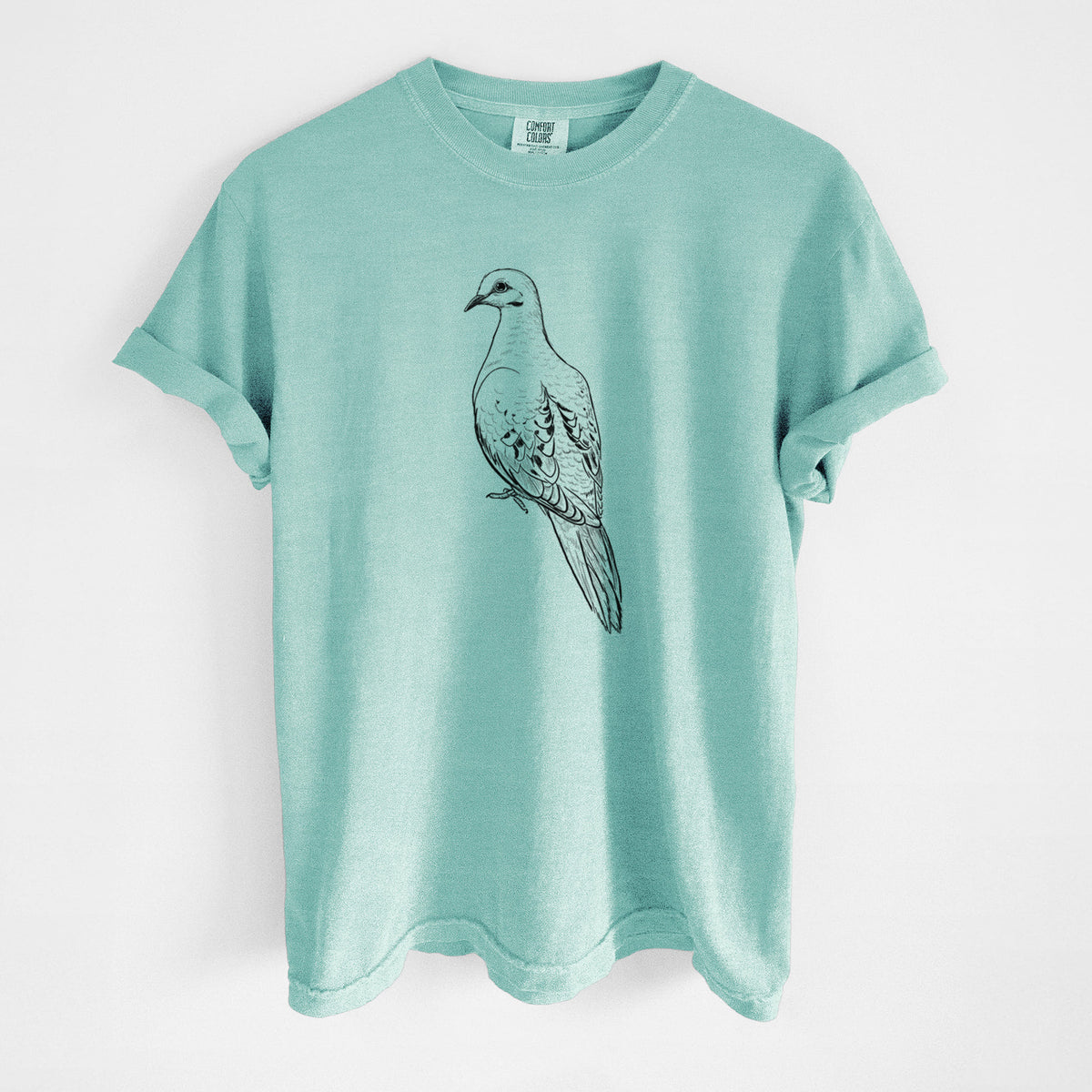 Chalky mint Comfort Colors t-shirt laid flat, printed with a detailed black ink sketch of a mourning dove perched.