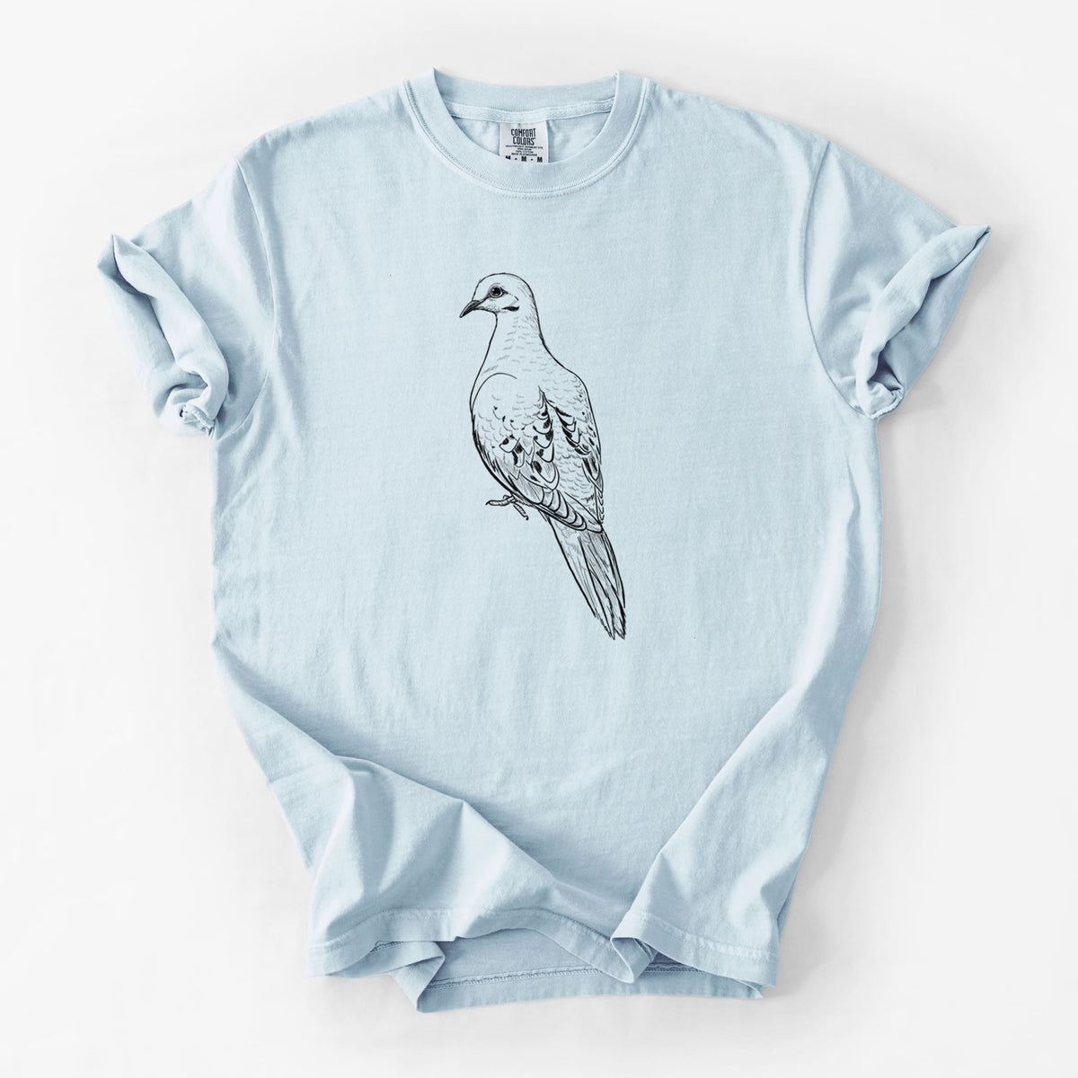 Chambray blue Comfort Colors t-shirt laid flat, printed with a detailed black ink sketch of a mourning dove perched.