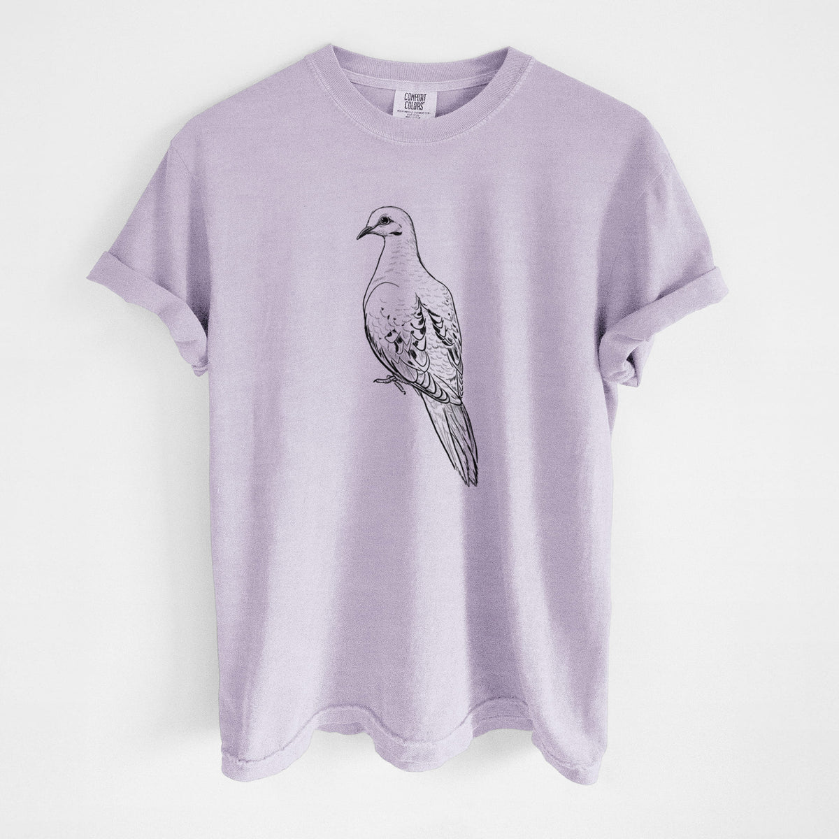 Orchid purple Comfort Colors t-shirt laid flat, printed with a detailed black ink sketch of a mourning dove perched.