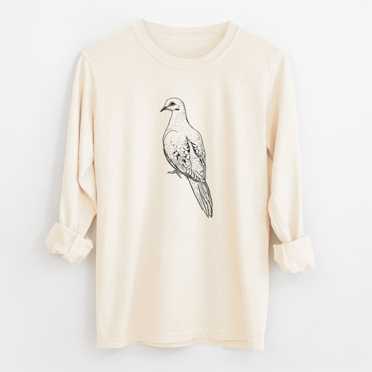 Ivory Comfort Colors long sleeve shirt laid flat with the cuffs rolled, printed with a detailed black ink sketch of a mourning dove perched.