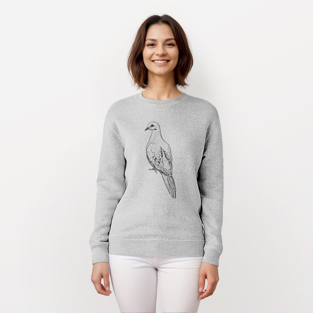 Woman wearing a knit sweatshirt printed with a detailed black ink sketch of a mourning dove perched.