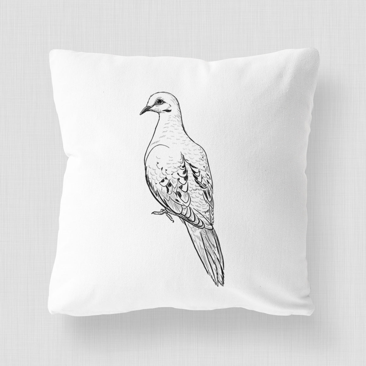 White pillow cover printed with a detailed black ink sketch of a mourning dove perched.