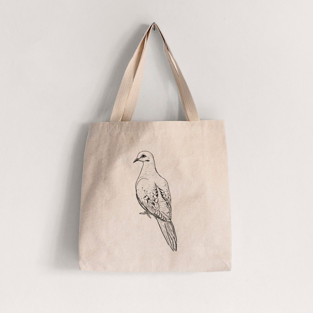 Natural canvas tote bag printed with a detailed black ink sketch of a mourning dove perched.