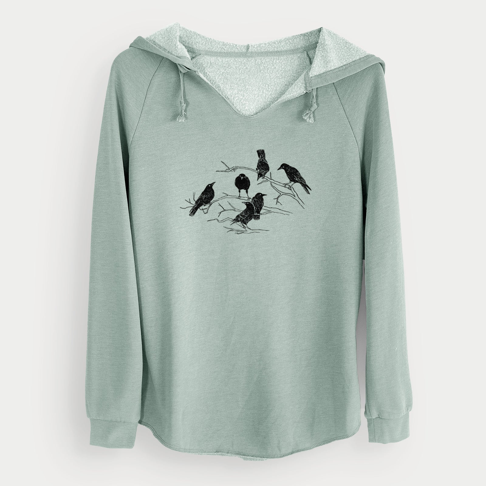 Sage green women's Cali Wave hooded sweatshirt laid flat, printed with a black ink illustration of a group of crows perched on bare branches.