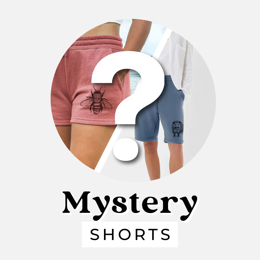 Mystery shorts: pink sweat shorts with a honey bee illustration and blue shorts with a small nature design behind a question mark.