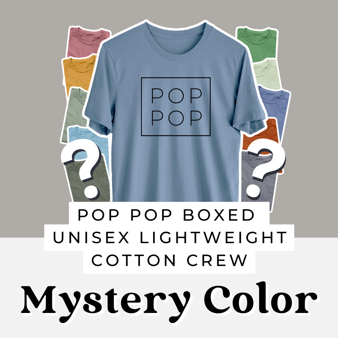 Mystery color Pop Pop Boxed unisex cotton crewneck tee printed with POP POP inside a square outline, surrounded by assorted shirt colors.