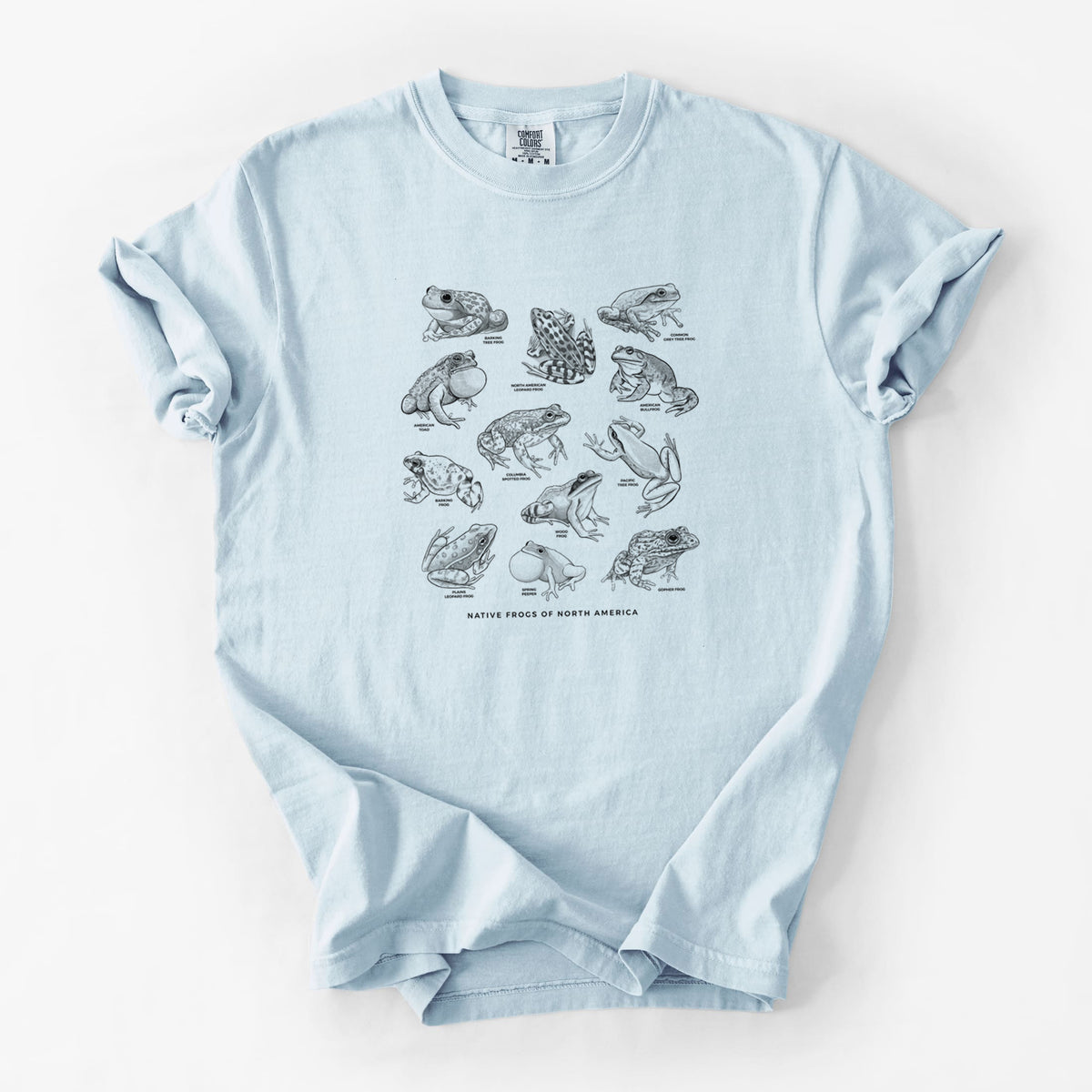 Chambray blue Comfort Colors t-shirt laid flat, printed with a chart of black ink illustrations of North American frog species.