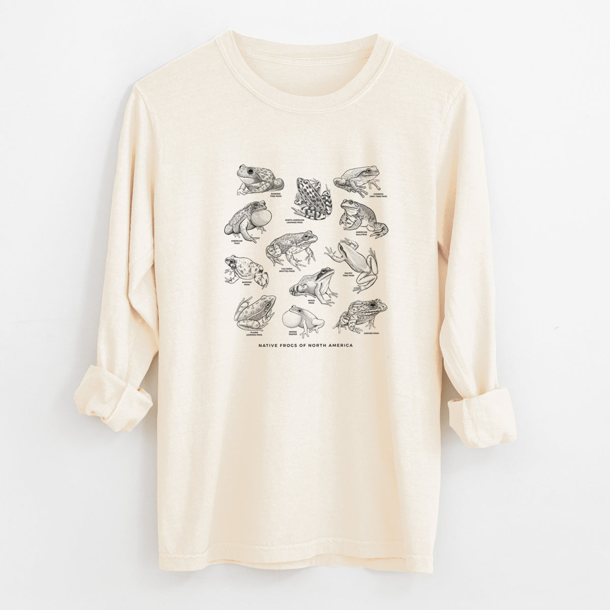 Ivory Comfort Colors long sleeve shirt laid flat with the cuffs rolled, printed with a chart of black ink illustrations of North American frog species.
