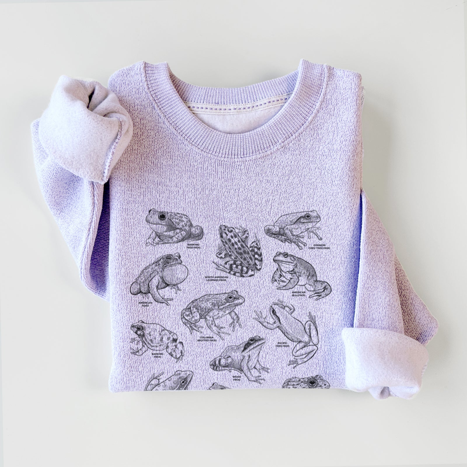 Ice purple knit sweatshirt printed with a chart of black ink illustrations of North American frog species, styled flat.