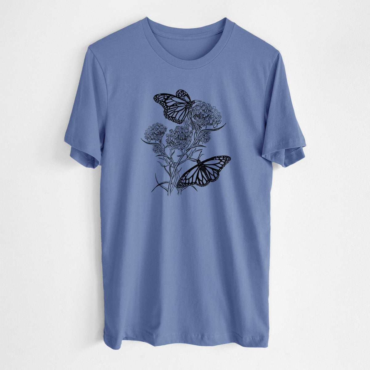 Blue bell lightweight cotton t-shirt laid flat, printed with a black ink illustration of two monarch butterflies on flowering milkweed.