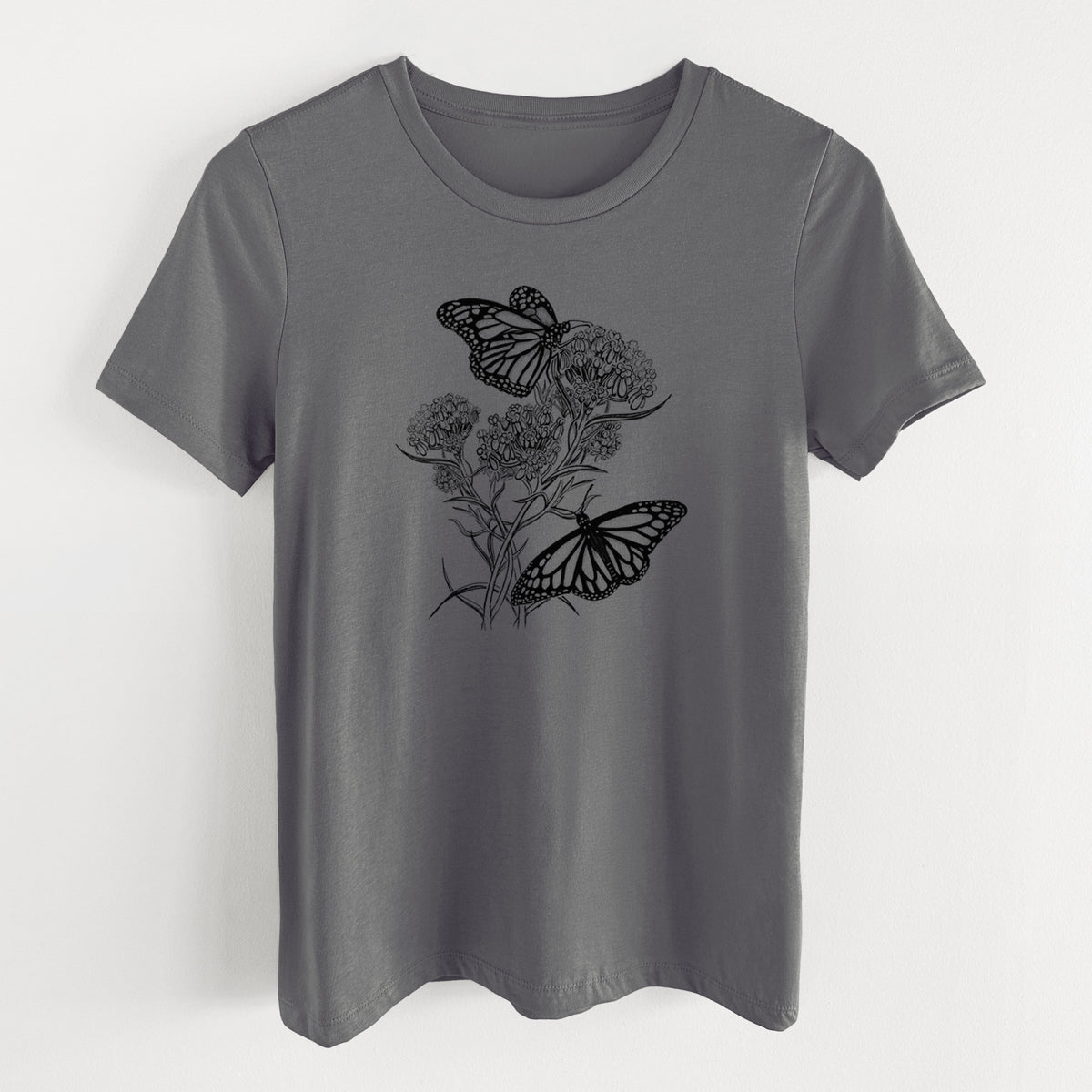 Asphalt women's relaxed fit cotton t-shirt laid flat, printed with a black ink illustration of two monarch butterflies on flowering milkweed.