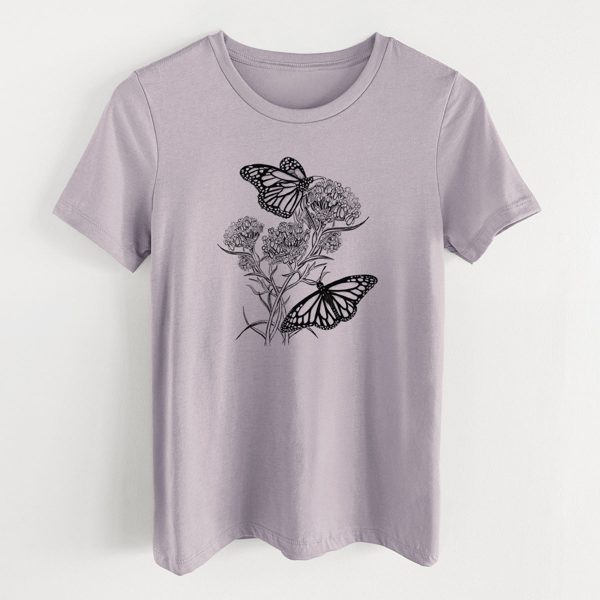 Light violet women's relaxed fit cotton t-shirt laid flat, printed with a black ink illustration of two monarch butterflies on flowering milkweed.