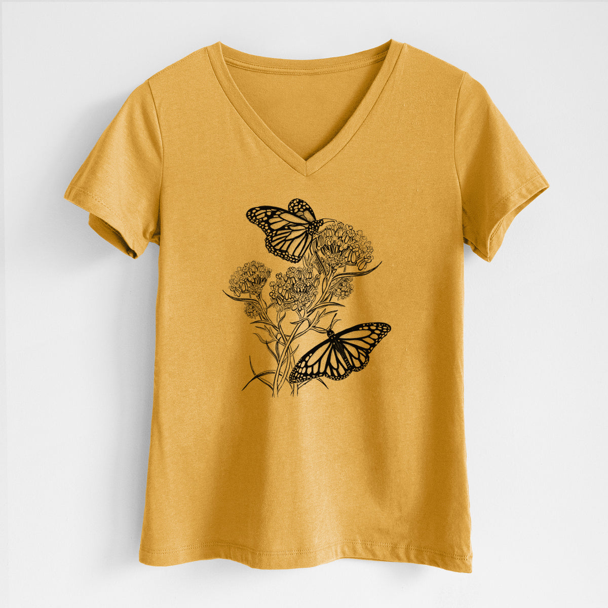 Honeycomb yellow women's relaxed fit cotton V-neck t-shirt laid flat, printed with a black ink illustration of two monarch butterflies on flowering milkweed.