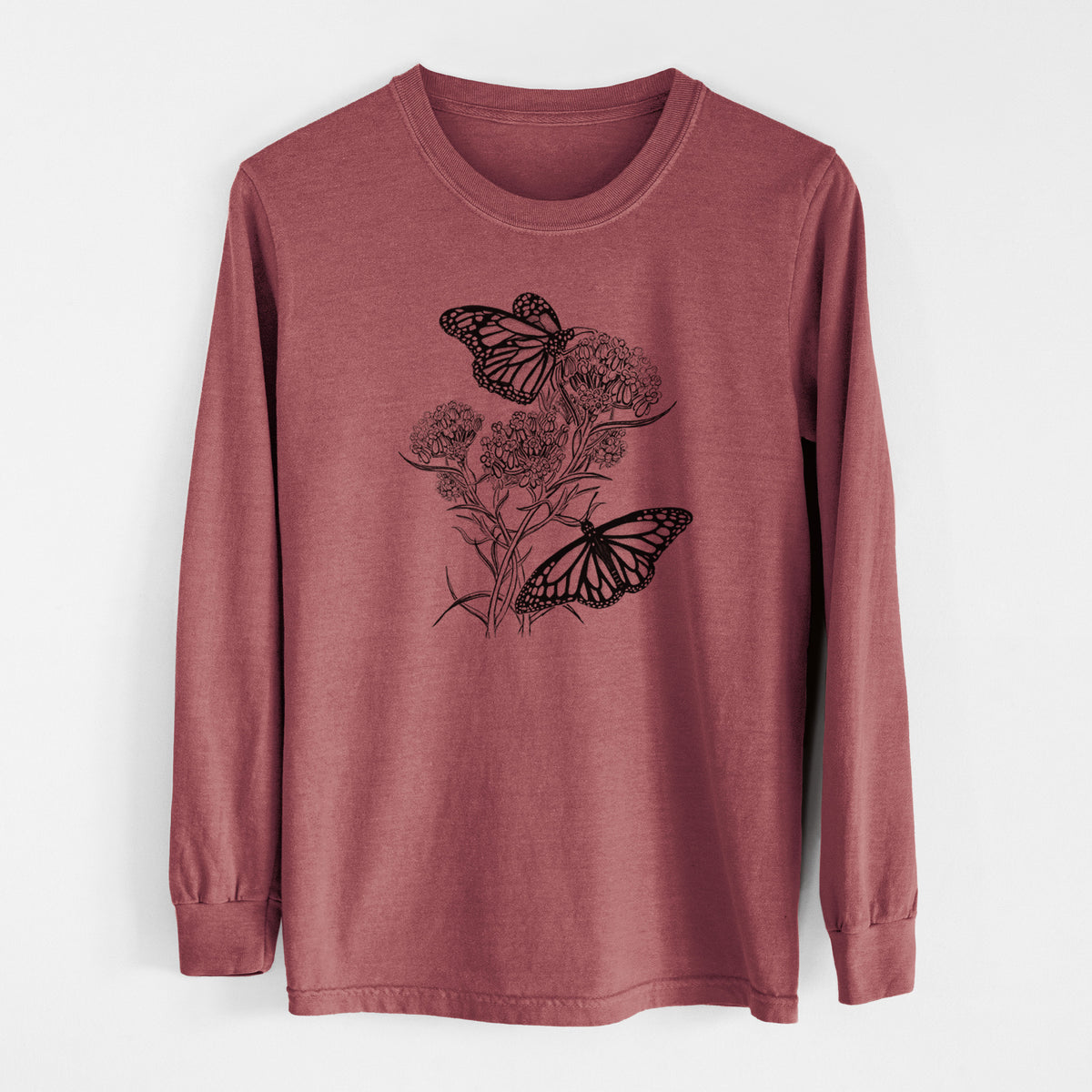 Brick red Comfort Colors long sleeve shirt laid flat, printed with a black ink illustration of two monarch butterflies on flowering milkweed.