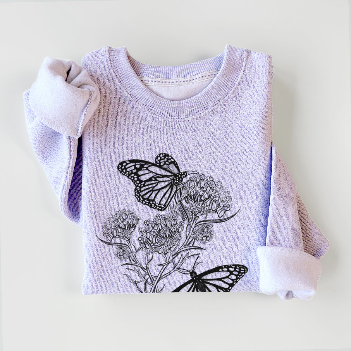 Ice purple knit sweatshirt printed with a black ink illustration of two monarch butterflies on flowering milkweed, styled flat.