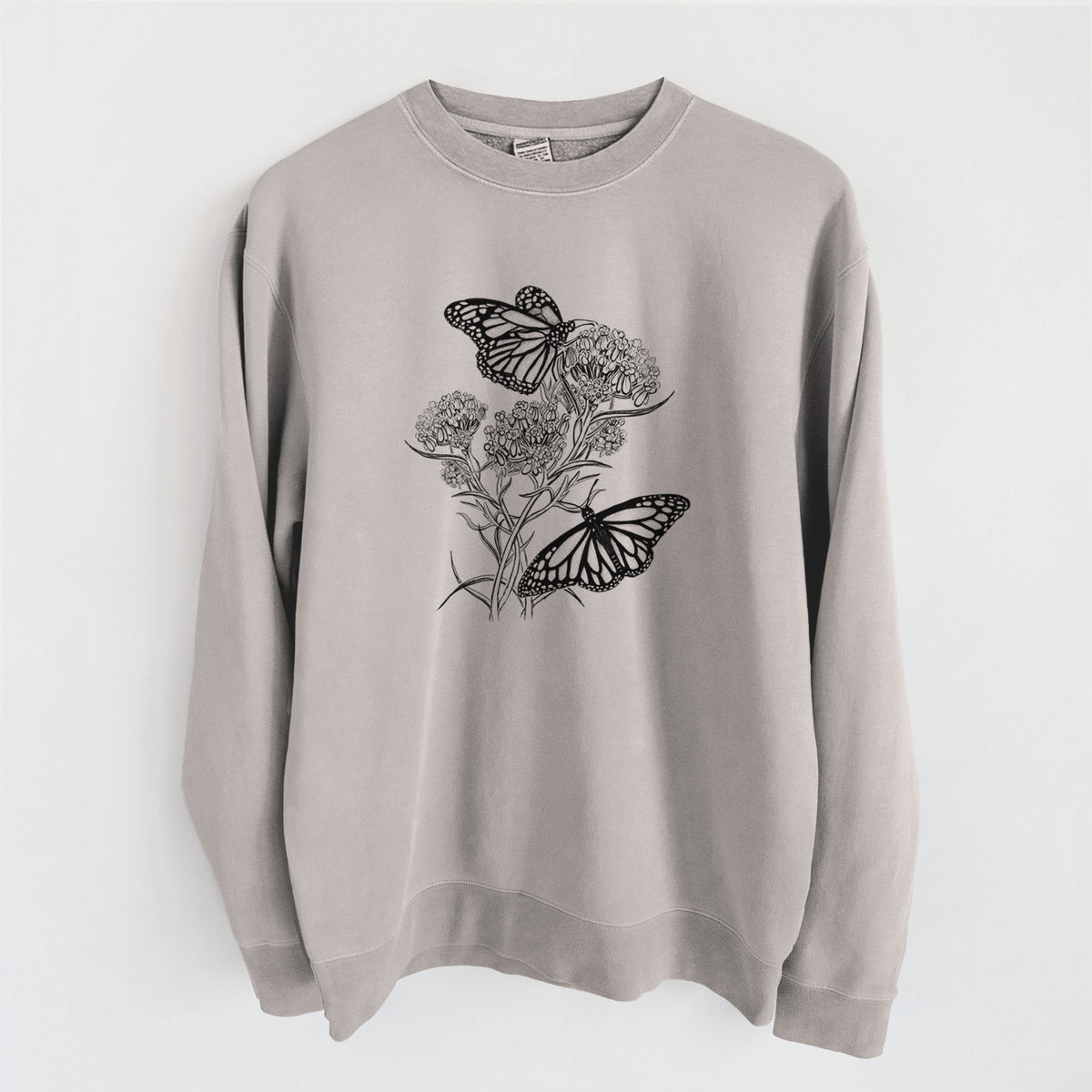 Cement grey pigment dyed crewneck sweatshirt laid flat, printed with a black ink illustration of two monarch butterflies on flowering milkweed.