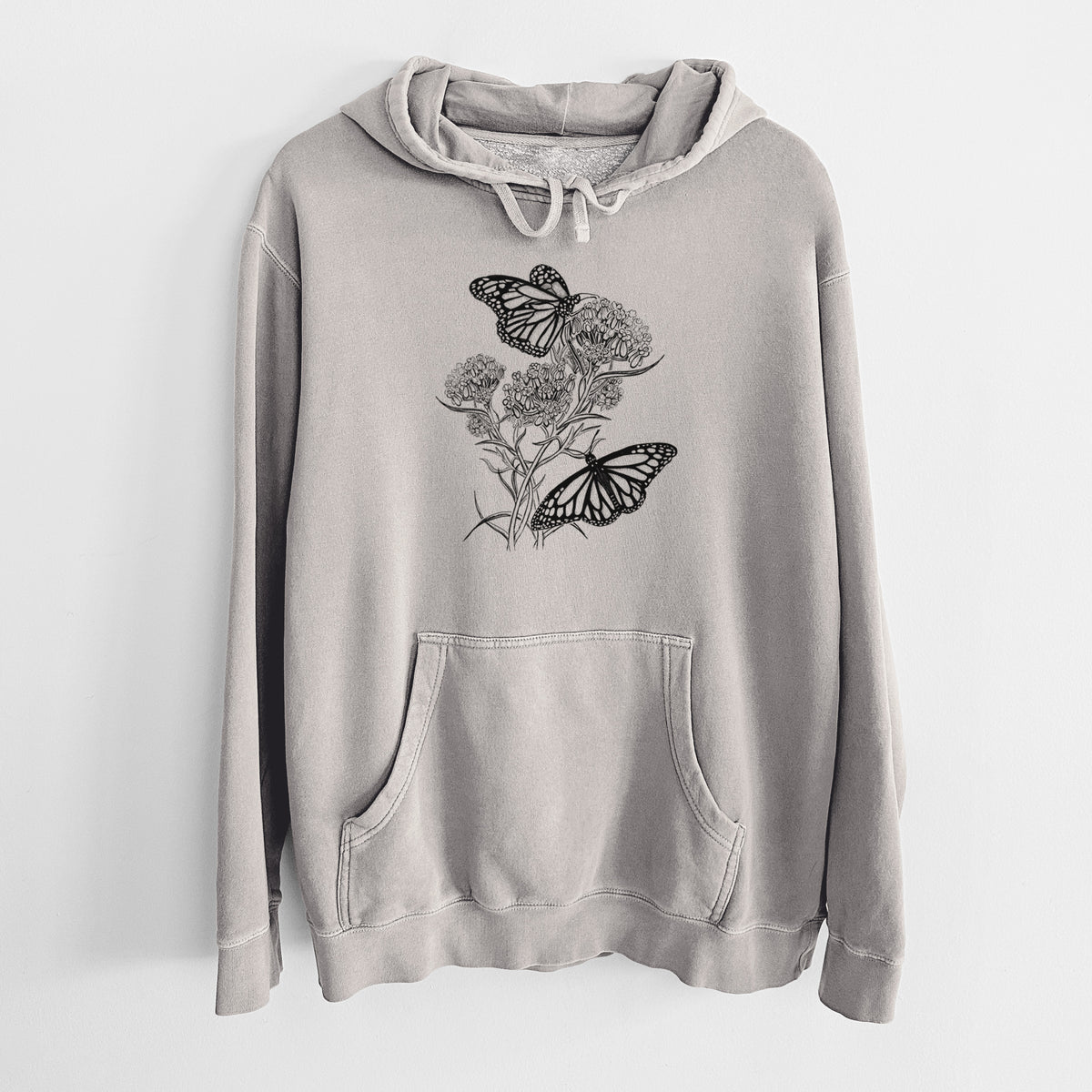 Cement grey pigment dyed hoodie laid flat, printed with a black ink illustration of two monarch butterflies on flowering milkweed.