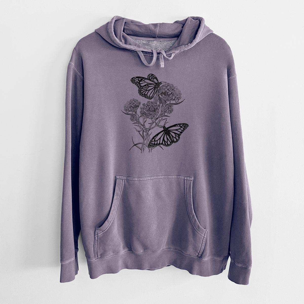 Plum purple pigment dyed hoodie laid flat, printed with a black ink illustration of two monarch butterflies on flowering milkweed.