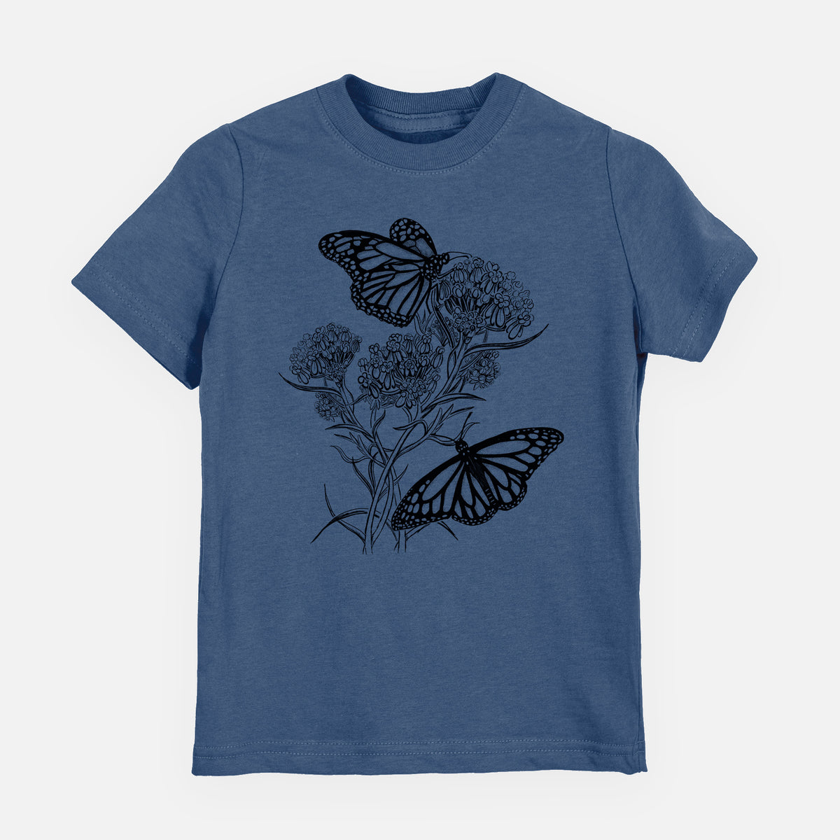 Indigo blue youth t-shirt laid flat, printed with a black ink illustration of two monarch butterflies on flowering milkweed.